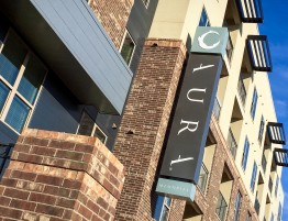 Aura Memorial Apartments LED Illuminated Identity Blade Sign on Building