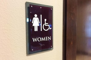 Aura 33Hundred Apartments Women Restroom Sign with ADA/Braille