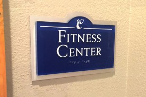Arium Apartments Fitness Center ID with ADA/Braille on Clear Acrylic with Brushed Aluminum Backer