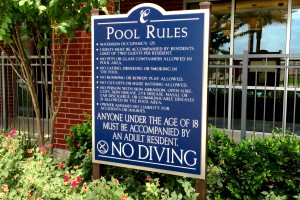 Arium Apartments Pool Rules Sign on Post