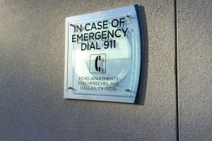 Echo City Apartments In Case of Emergency Dial 911 Sign by Pool