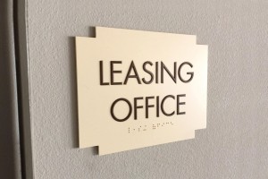 The Pines at Woodcreek Leasing Office ID with ADA/Braille
