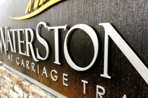 WaterStone at Carriage Trails Apartments - Contemporary Identity Monument with Brushed Aluminum Letters on Corten Steel for Rusted Design