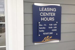 WaterStone at Carriage Trails Apartments - Leasing Office Sign with Office Hours on Stand-Offs