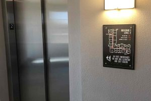 Main Street Lofts Evacuation Sign by Every Elevator to Meet Code Requirement