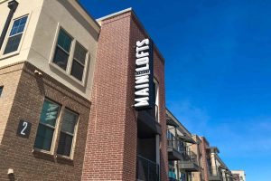 Main Street Lofts Industrial Design with Channel Letters onto Aluminum Cabinet Blade Sign