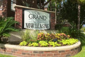 The Grand on Memorial Apartments Now Leasing Plaque on Existing Monument