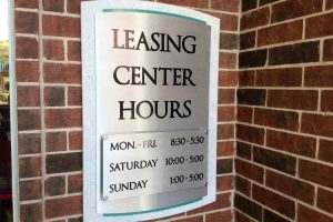 The Grand on Memorial Apartments Office Hours with Avonite Backer and Brushed Aluminum Face